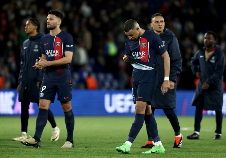 Kylian Mbappe walks off the pitch with PSG teammates after the French side